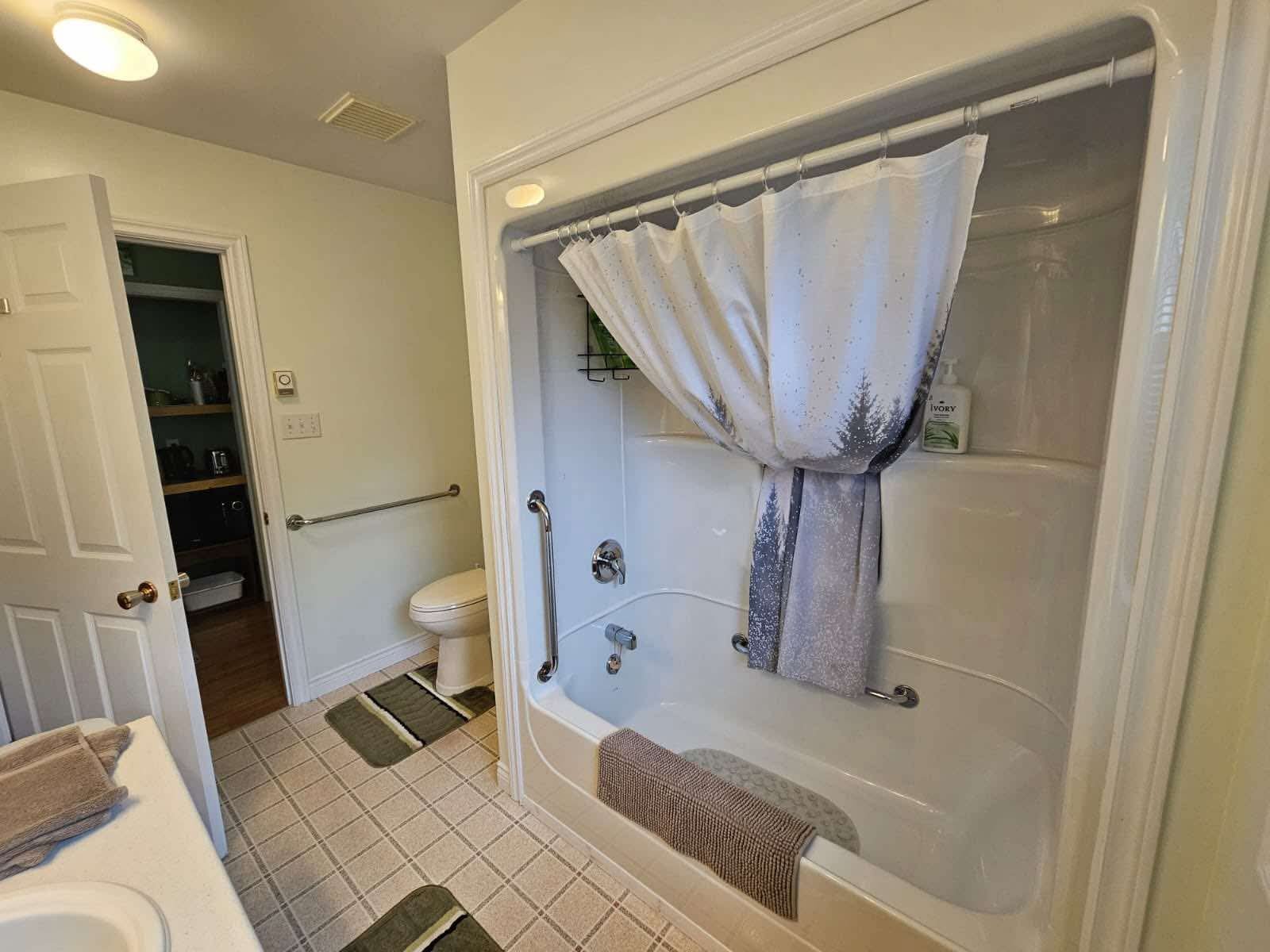Full bathroom with tub and shower combination, toilet and sink